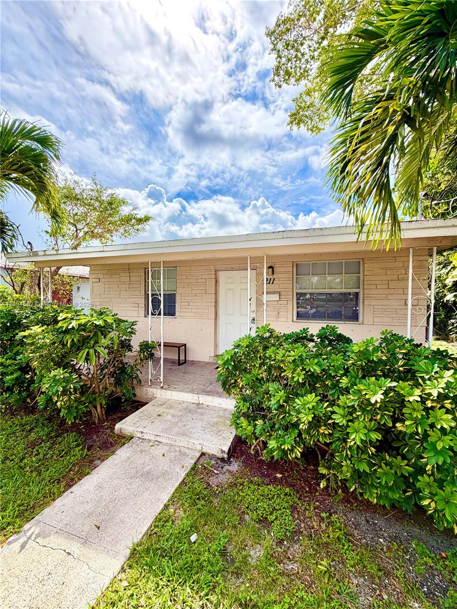 211 Stirling Road, Unit 1 Dania Beach, FL 33004 - Photo 2 of 21 front view of a house with a yard