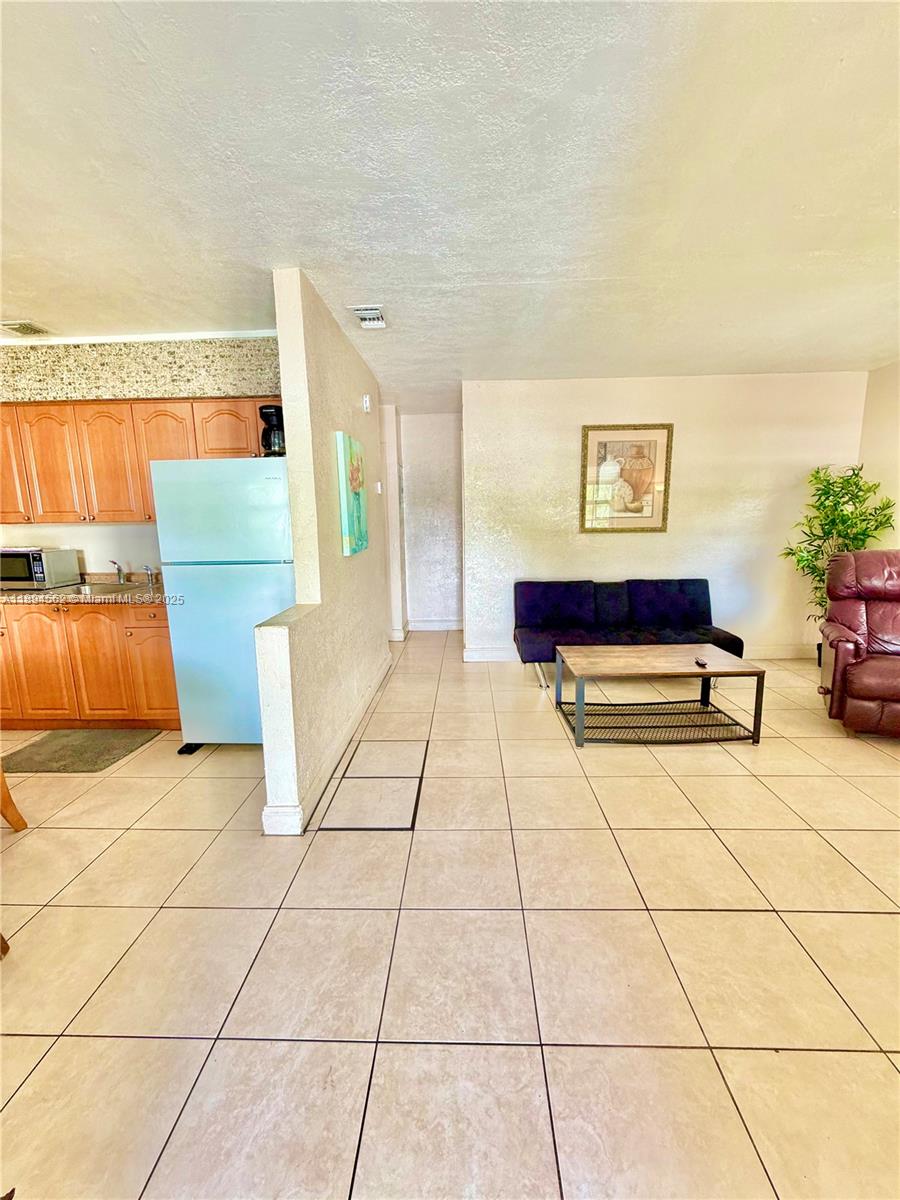 211 Stirling Road, Unit 1 Dania Beach, FL 33004 - Photo 3 of 21 a living room with furniture and a rug