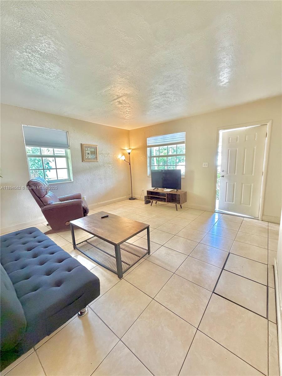 211 Stirling Road, Unit 1 Dania Beach, FL 33004 - Photo 8 of 21 a living room with furniture and a rug