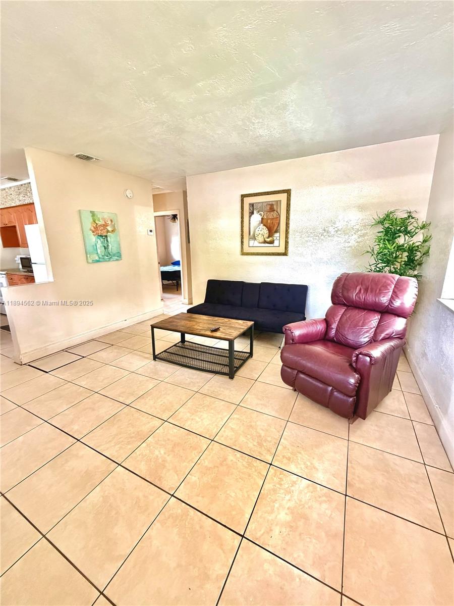 211 Stirling Road, Unit 1 Dania Beach, FL 33004 - Photo 10 of 21 a living room with furniture