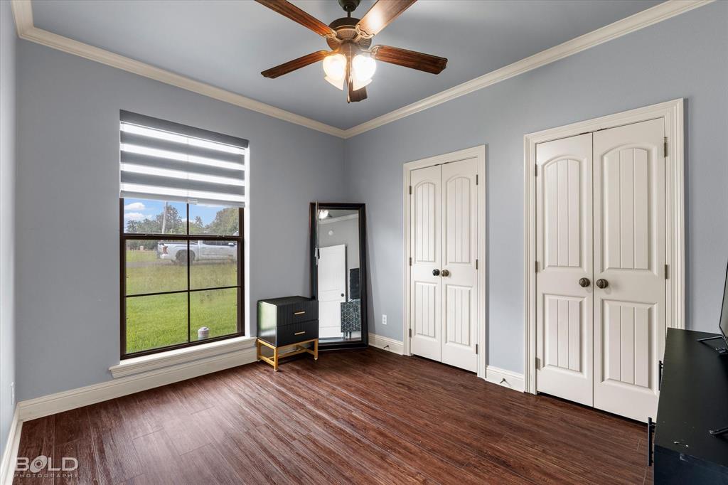 2220 Forest Hills Boulevard Haughton, LA 71037 - Photo 35 of 40 Interior room featuring wood-finish flooring, a ceiling fan with integrated lighting, and crown molding