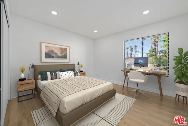 a bedroom with a bed and a potted plant