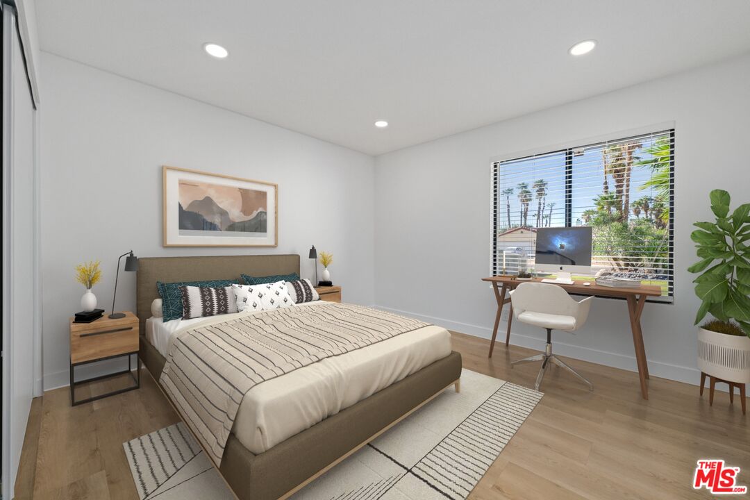 67350 Medano Road Cathedral City, CA 92234 - Photo 12 of 20 a bedroom with a bed and a potted plant
