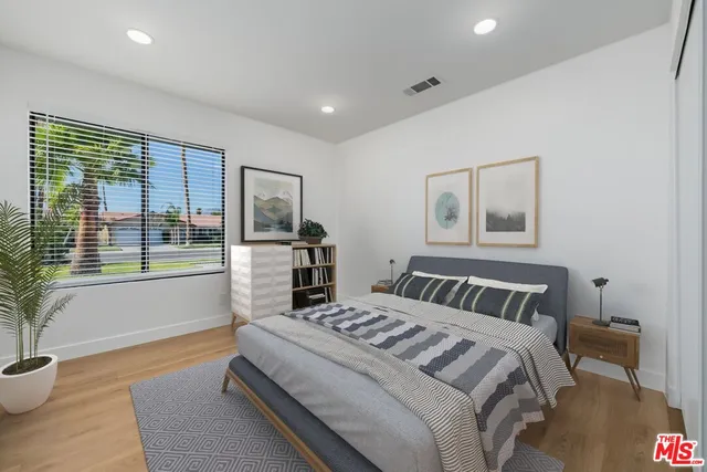 a bedroom with a bed and glass window