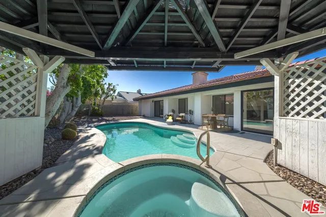 a view of a porch with furniture and a yard