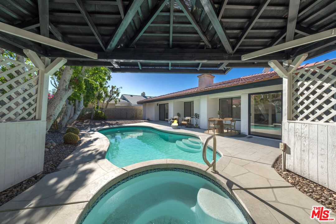 67350 Medano Road Cathedral City, CA 92234 - Photo 16 of 20 a view of a porch with furniture and a yard