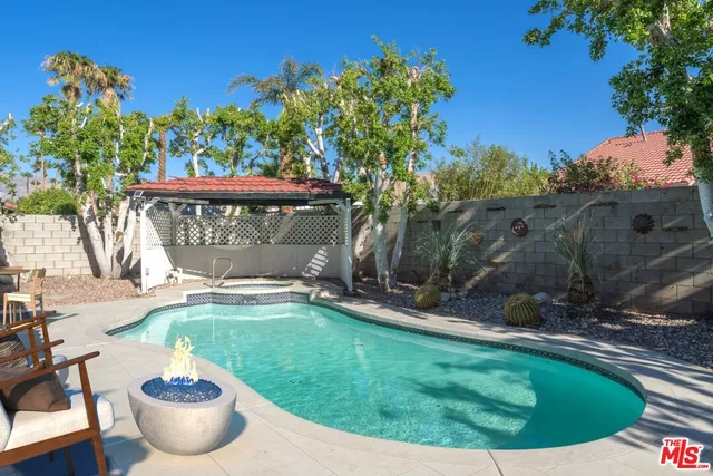 a view of a swimming pool with a yard