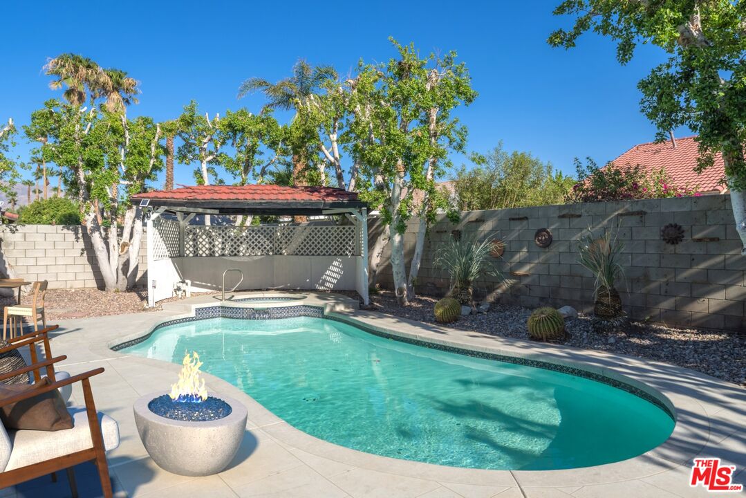 67350 Medano Road Cathedral City, CA 92234 - Photo 17 of 20 a view of a swimming pool with a yard