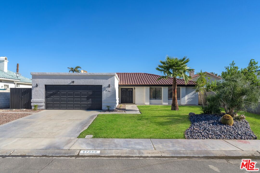 67350 Medano Road Cathedral City, CA 92234 - Photo 19 of 20 a front view of a house with a garden and yard