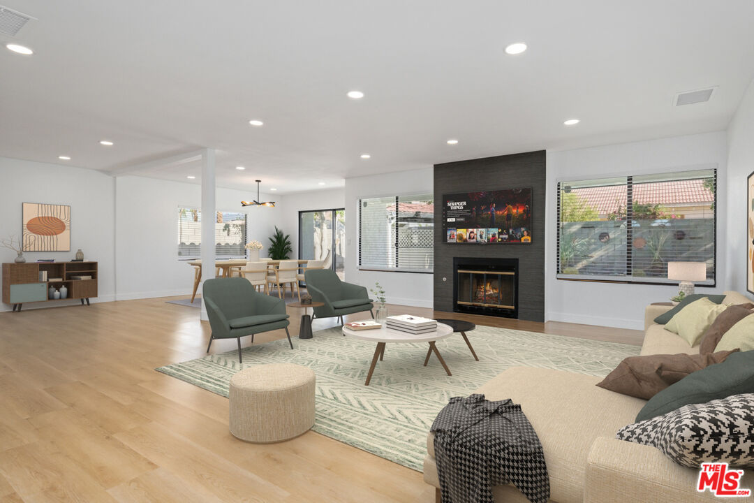 67350 Medano Road Cathedral City, CA 92234 - Photo 2 of 20 a living room with furniture kitchen view and a fireplace