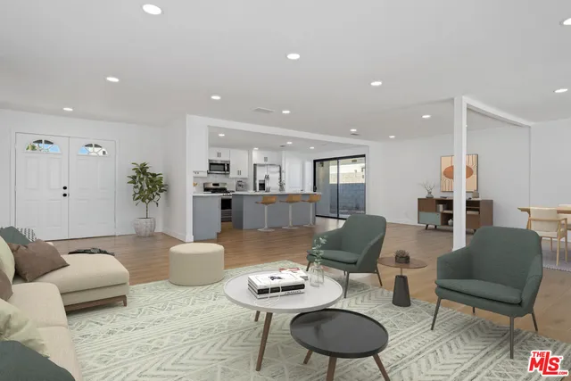 a living room with furniture and a dining table with kitchen view