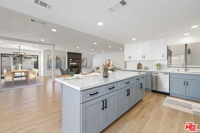 a kitchen with sink stove and cabinets