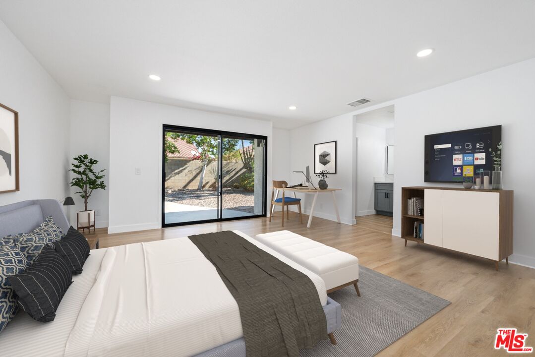 67350 Medano Road Cathedral City, CA 92234 - Photo 8 of 20 a bedroom with a large bed and a large window