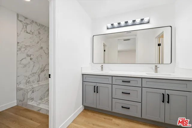 a bathroom with a double vanity sink mirror and