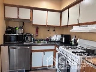 44 Judson Street, Unit 9A Edison, NJ 08837 - Photo 3 of 12 a kitchen with stainless steel appliances granite countertop a stove and a white cabinets