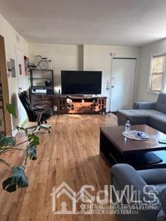 44 Judson Street, Unit 9A Edison, NJ 08837 - Photo 10 of 12 a living room with furniture and a flat screen tv