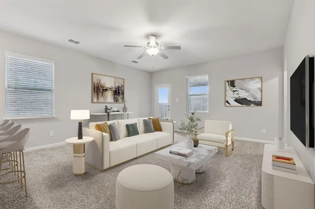 a living room with furniture and a flat screen tv