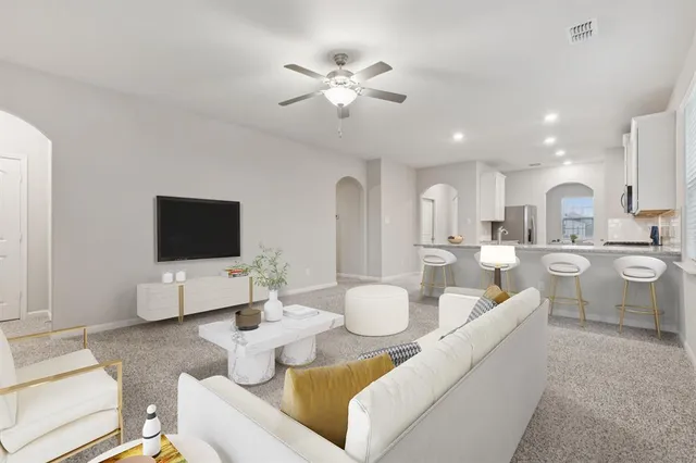 a living room with furniture and a flat screen tv