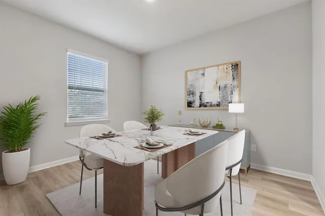 a dining room with furniture and window