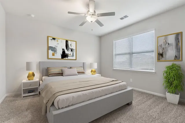 a bedroom with a bed and a window