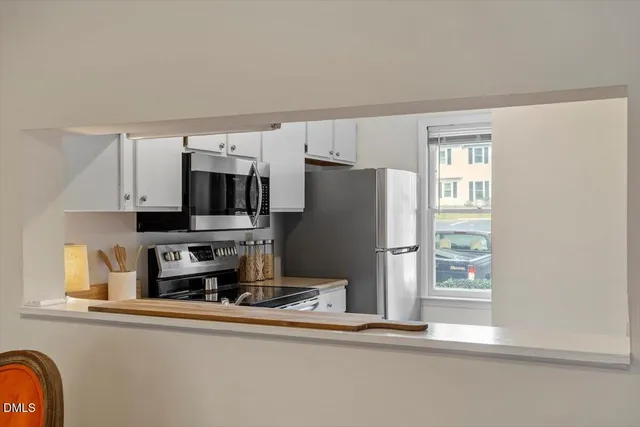 a kitchen with stainless steel appliances a refrigerator and a stove top oven