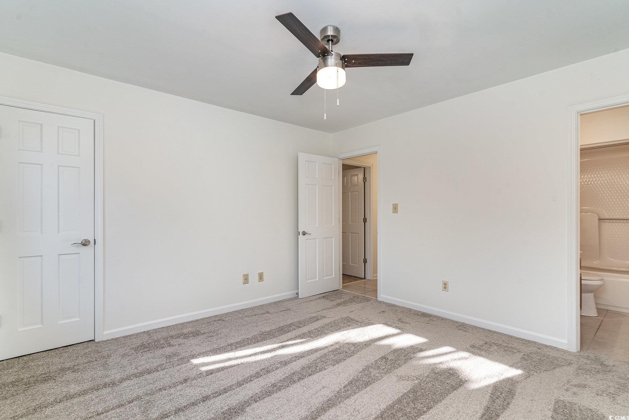783 Kittiwake Lane Murrells Inlet, SC 29576 - Photo 14 of 21 Unfurnished bedroom with connected bathroom, light