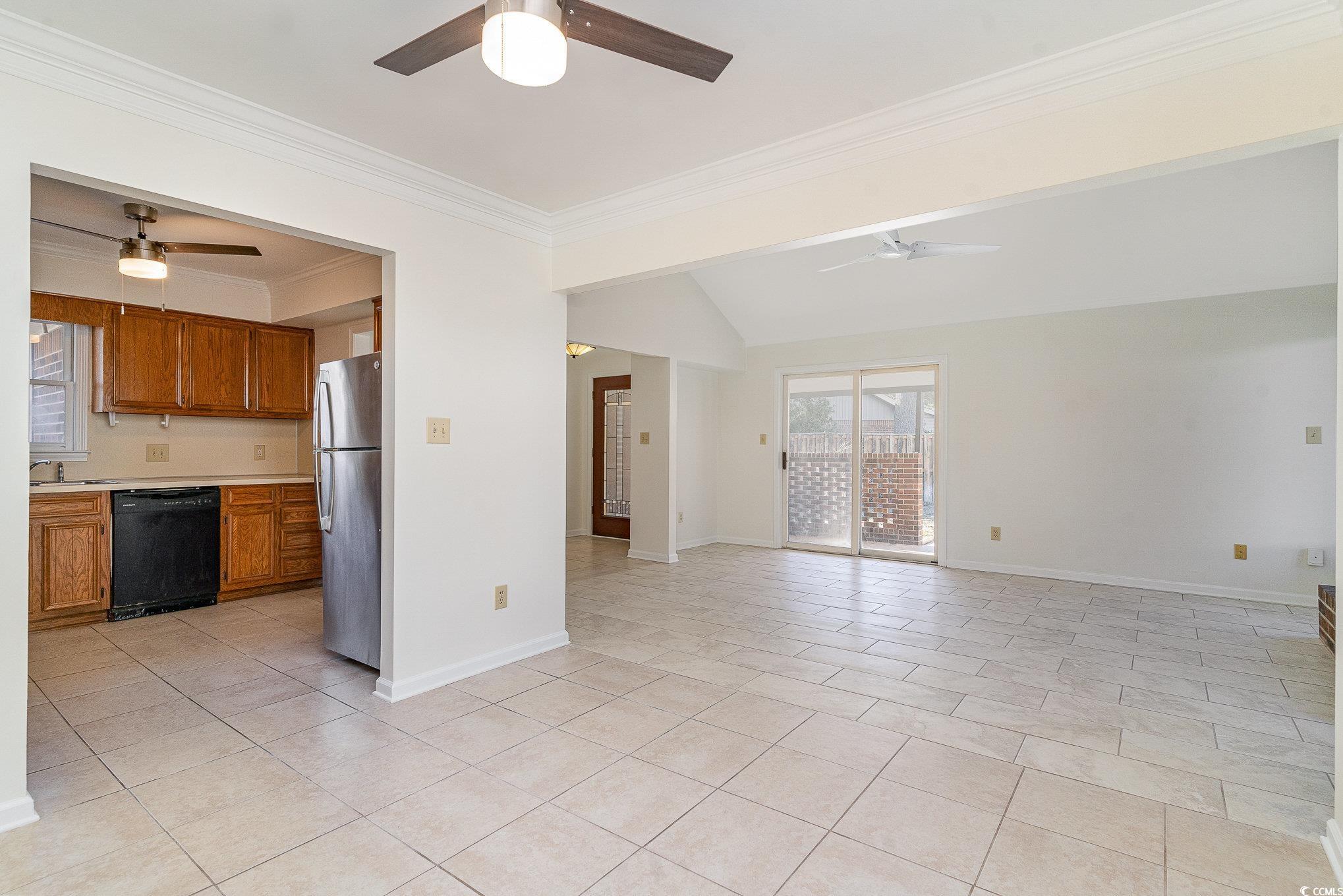 Unfurnished living room featuring light tile patte