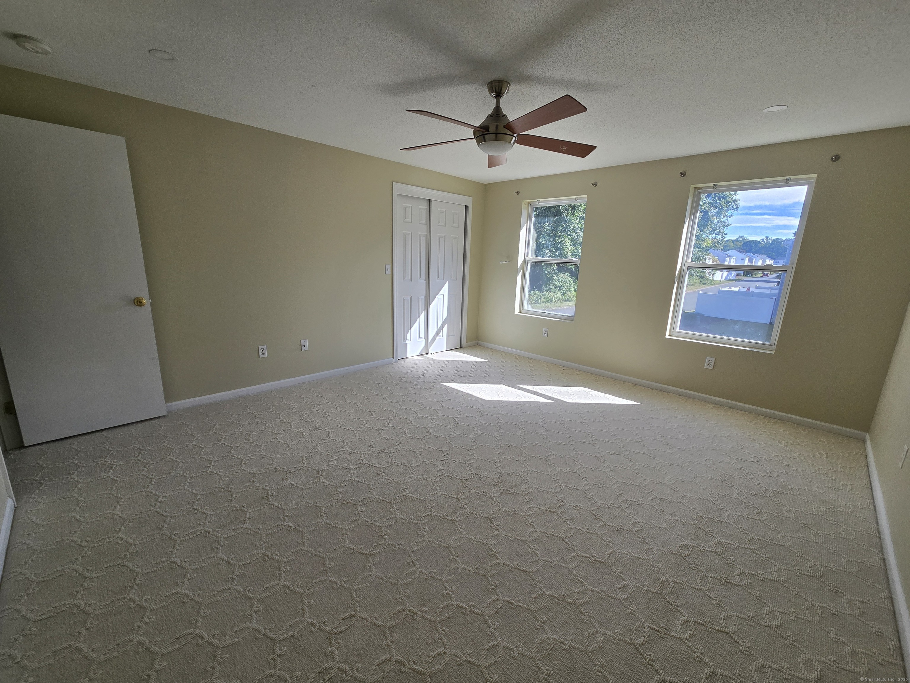 5 Periwinkle Lane, Unit 5 Glastonbury, CT 06033 - Photo 15 of 23 a view of a livingroom with a ceiling fan and window