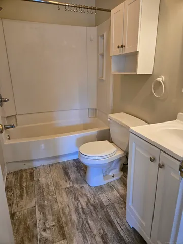 a bathroom with a toilet and a shower