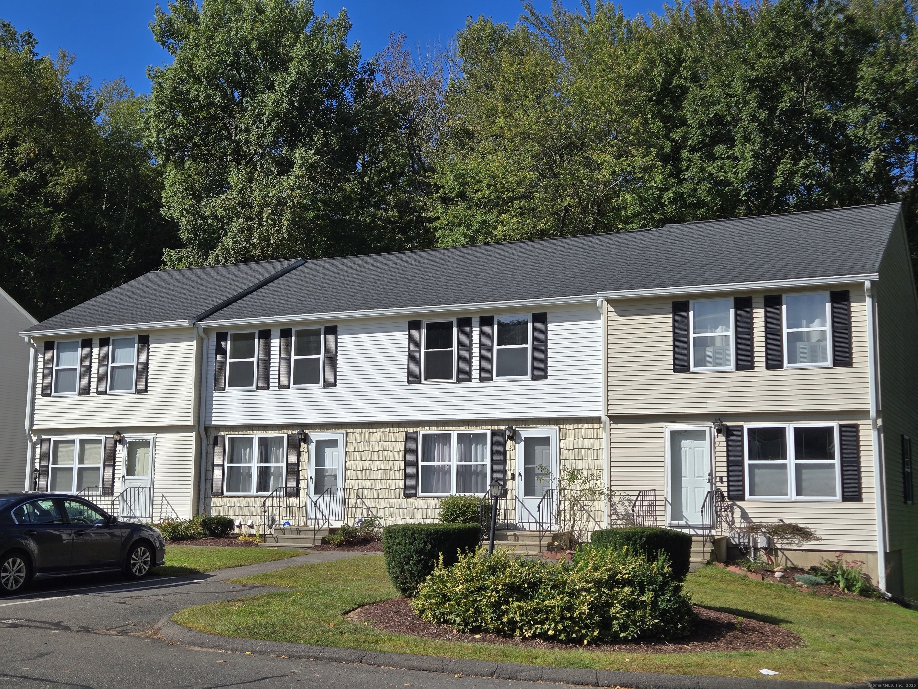 5 Periwinkle Lane, Unit 5 Glastonbury, CT 06033 - Photo 2 of 23 a aerial view of a brick house with a yard table and chairs