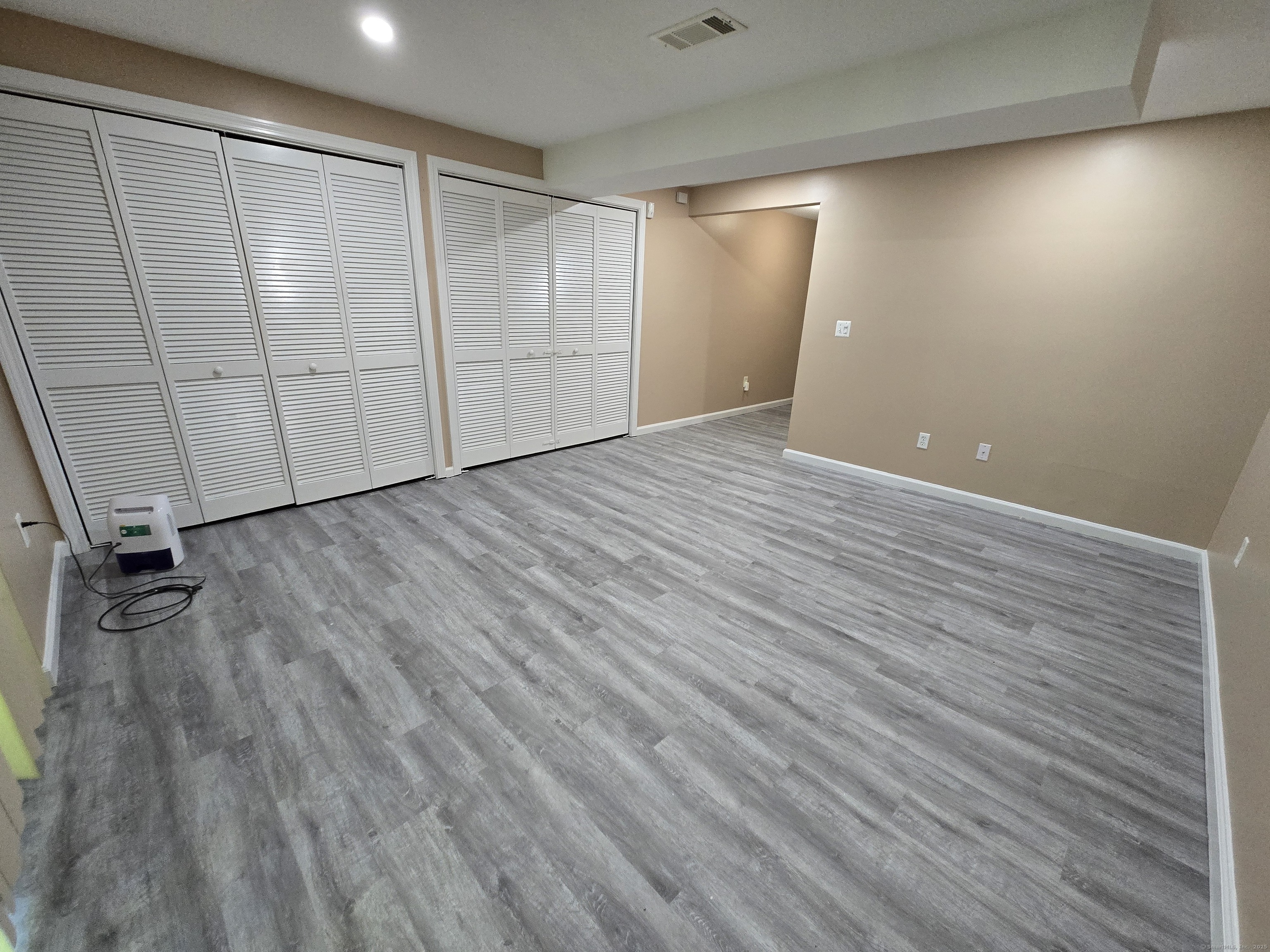 5 Periwinkle Lane, Unit 5 Glastonbury, CT 06033 - Photo 21 of 23 an empty room with wooden floor and windows
