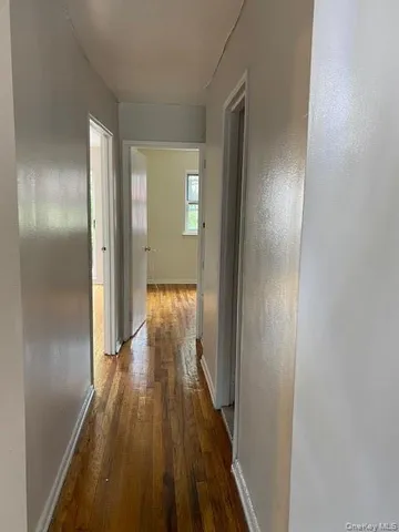 a view of a room with wooden floor