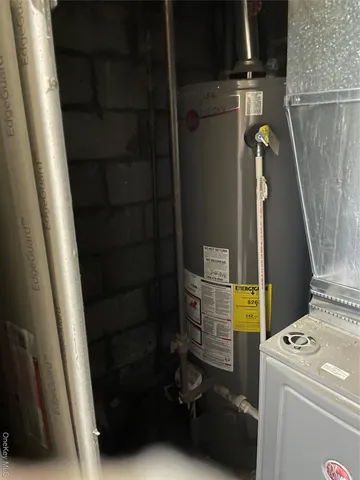 a bathroom with a granite countertop sink a washer and dryer