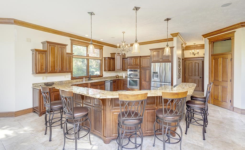 7417 Winding Way Roscoe, IL 61073 - Photo 11 of 40 a view of a dining room and livingroom with furniture wooden floor a chandelier