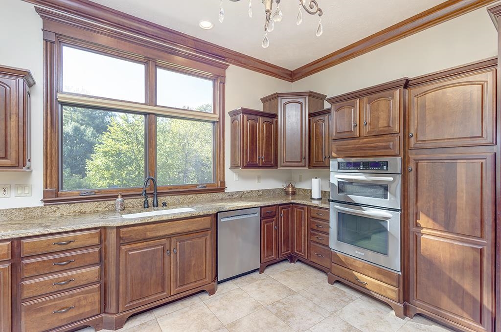 7417 Winding Way Roscoe, IL 61073 - Photo 12 of 40 a kitchen with stainless steel appliances granite countertop a sink and cabinets