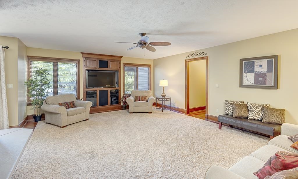 7417 Winding Way Roscoe, IL 61073 - Photo 22 of 40 a living room with furniture and a fireplace