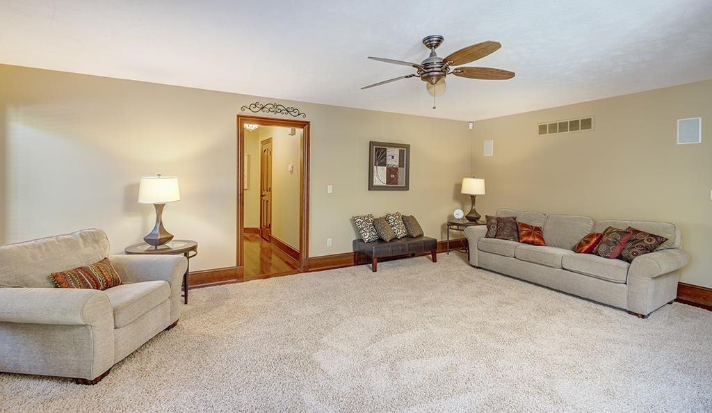 7417 Winding Way Roscoe, IL 61073 - Photo 23 of 40 a living room with furniture and a chandelier