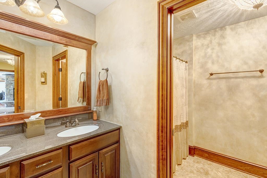 7417 Winding Way Roscoe, IL 61073 - Photo 27 of 40 a bathroom with a sink and a mirror