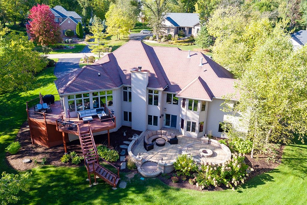 7417 Winding Way Roscoe, IL 61073 - Photo 3 of 40 a view of a house with swimming pool lawn chairs and a yard
