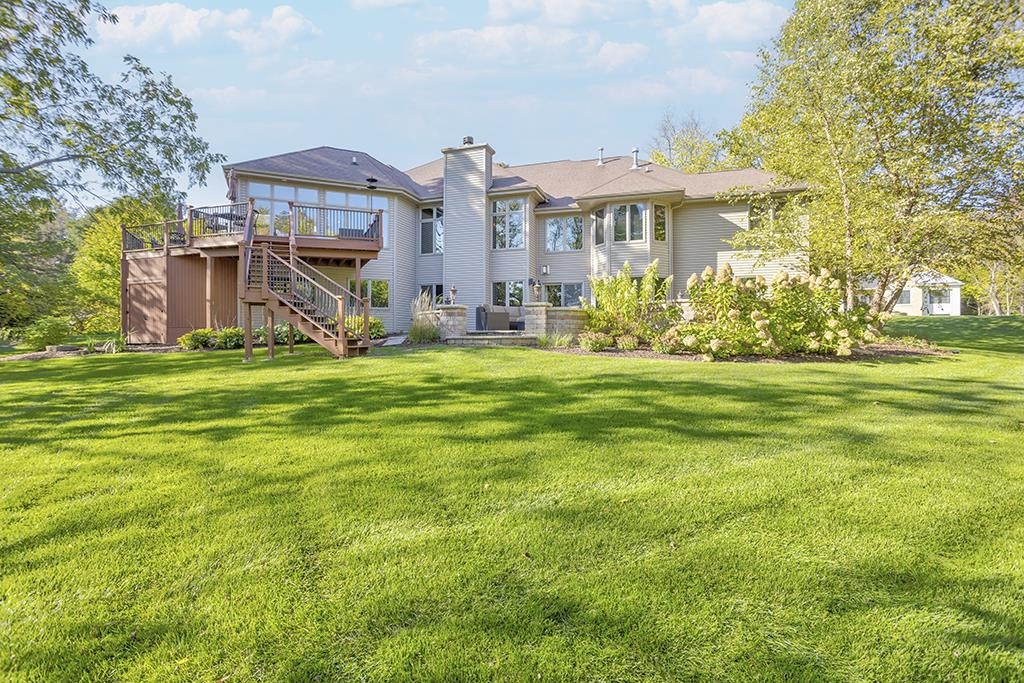 7417 Winding Way Roscoe, IL 61073 - Photo 32 of 40 a view of a house with a big yard and large trees