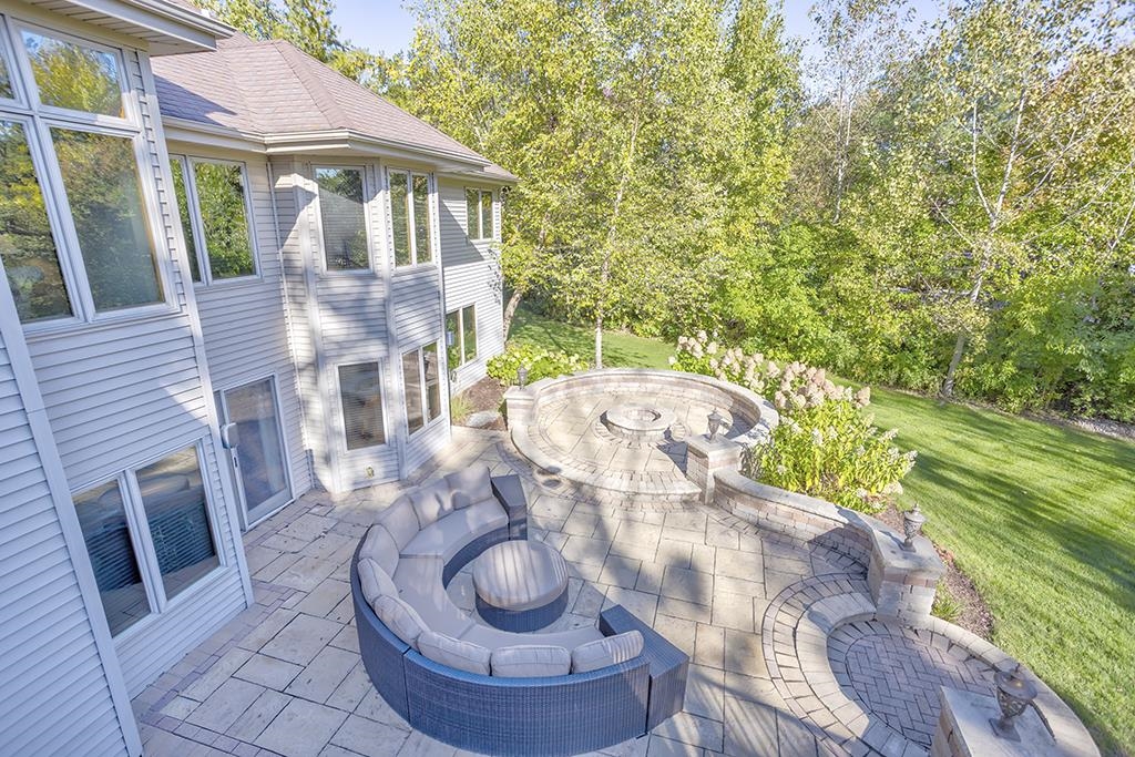 7417 Winding Way Roscoe, IL 61073 - Photo 34 of 40 a view of a patio with table and chairs potted plants with wooden floor and fence