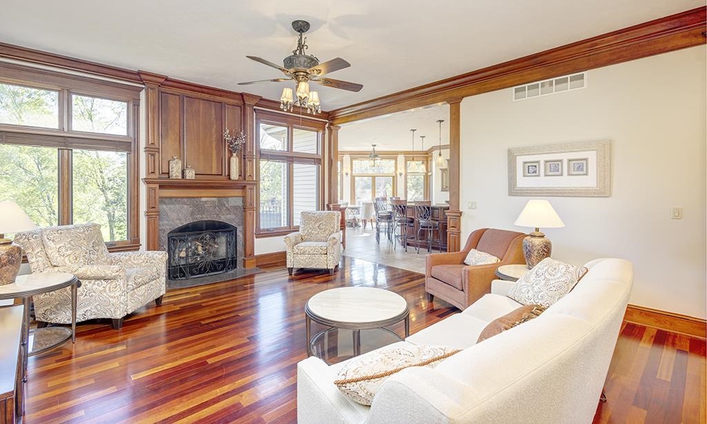 7417 Winding Way Roscoe, IL 61073 - Photo 4 of 40 a living room with furniture a fireplace and a large window