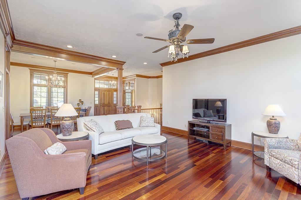 7417 Winding Way Roscoe, IL 61073 - Photo 6 of 40 a living room with fireplace furniture and a wooden floor