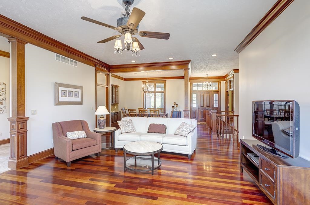 7417 Winding Way Roscoe, IL 61073 - Photo 7 of 40 a living room with furniture a rug and a flat screen tv