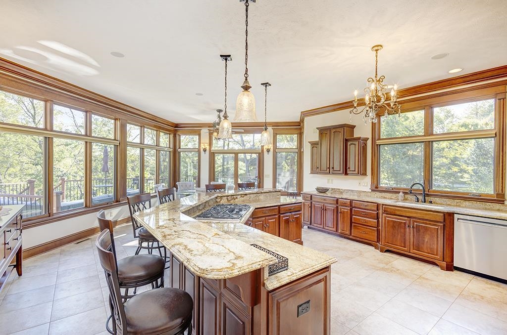 7417 Winding Way Roscoe, IL 61073 - Photo 8 of 40 a large kitchen with kitchen island a large window in it