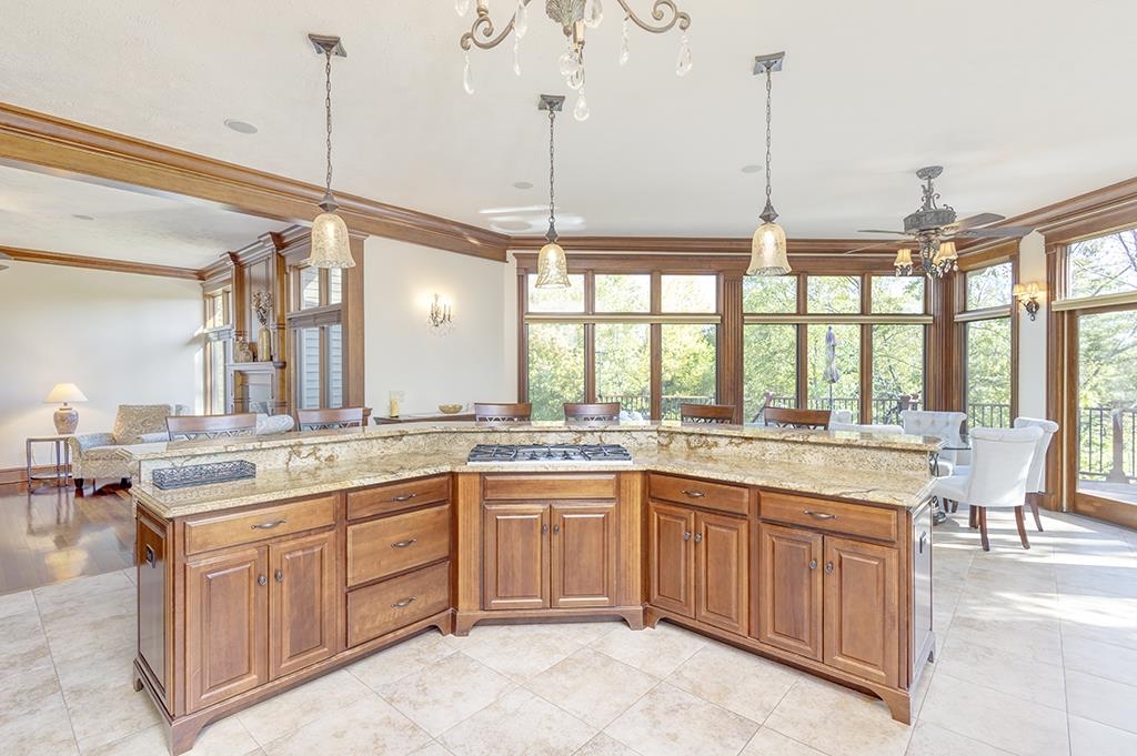 7417 Winding Way Roscoe, IL 61073 - Photo 10 of 40 a open kitchen with a sink a stove and chairs