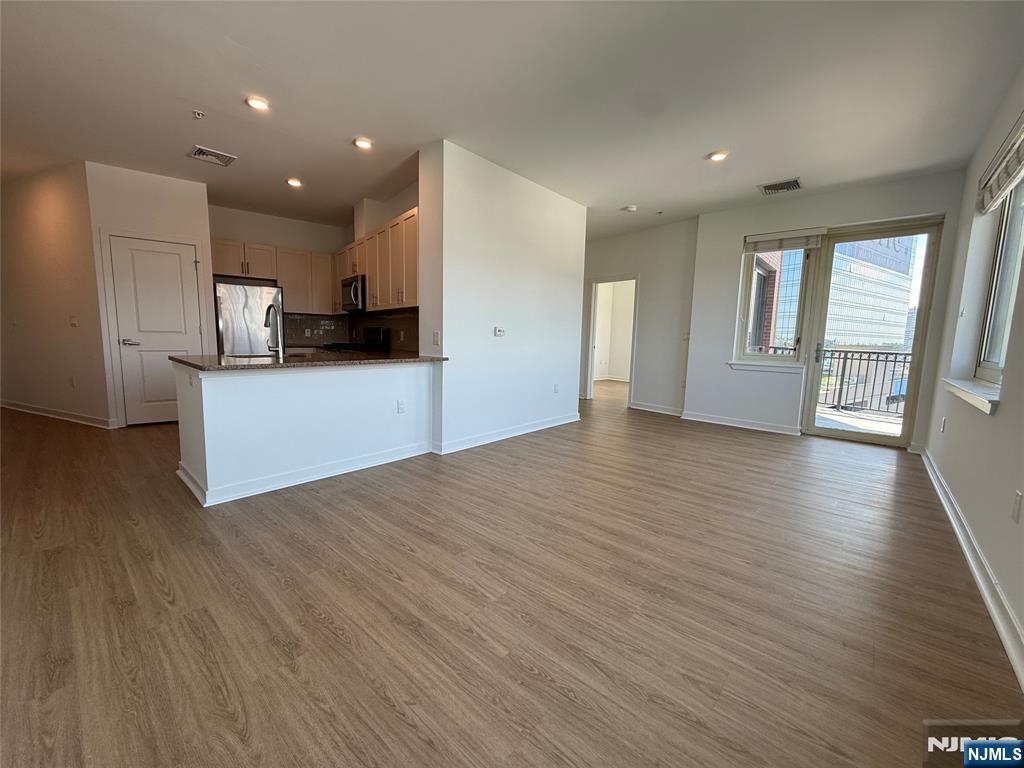 2050 North Central Road, Unit 710 Fort Lee, NJ 07024 - Photo 4 of 21 a view of a kitchen with a sink and wooden floor