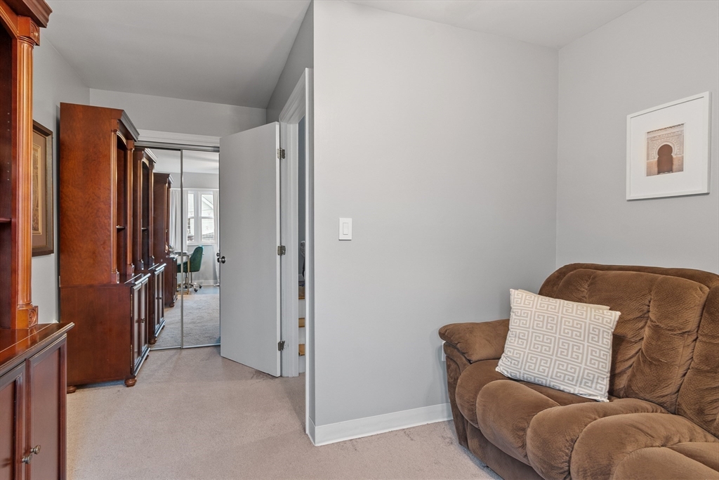 42 Farmland Road, Unit D Lowell, MA 01850 - Photo 15 of 26 a living room with furniture a couch and a window