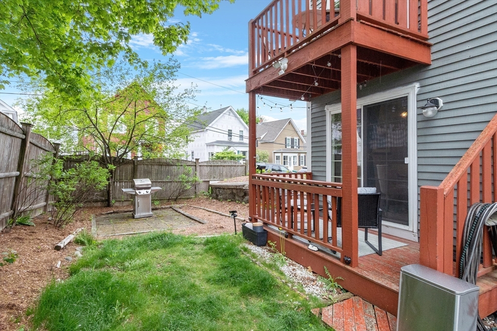 42 Farmland Road, Unit D Lowell, MA 01850 - Photo 20 of 26 a view of a chair and table in backyard of the house