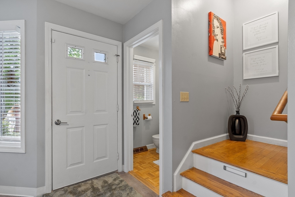 42 Farmland Road, Unit D Lowell, MA 01850 - Photo 2 of 26 a bedroom with a bed and a chandelier